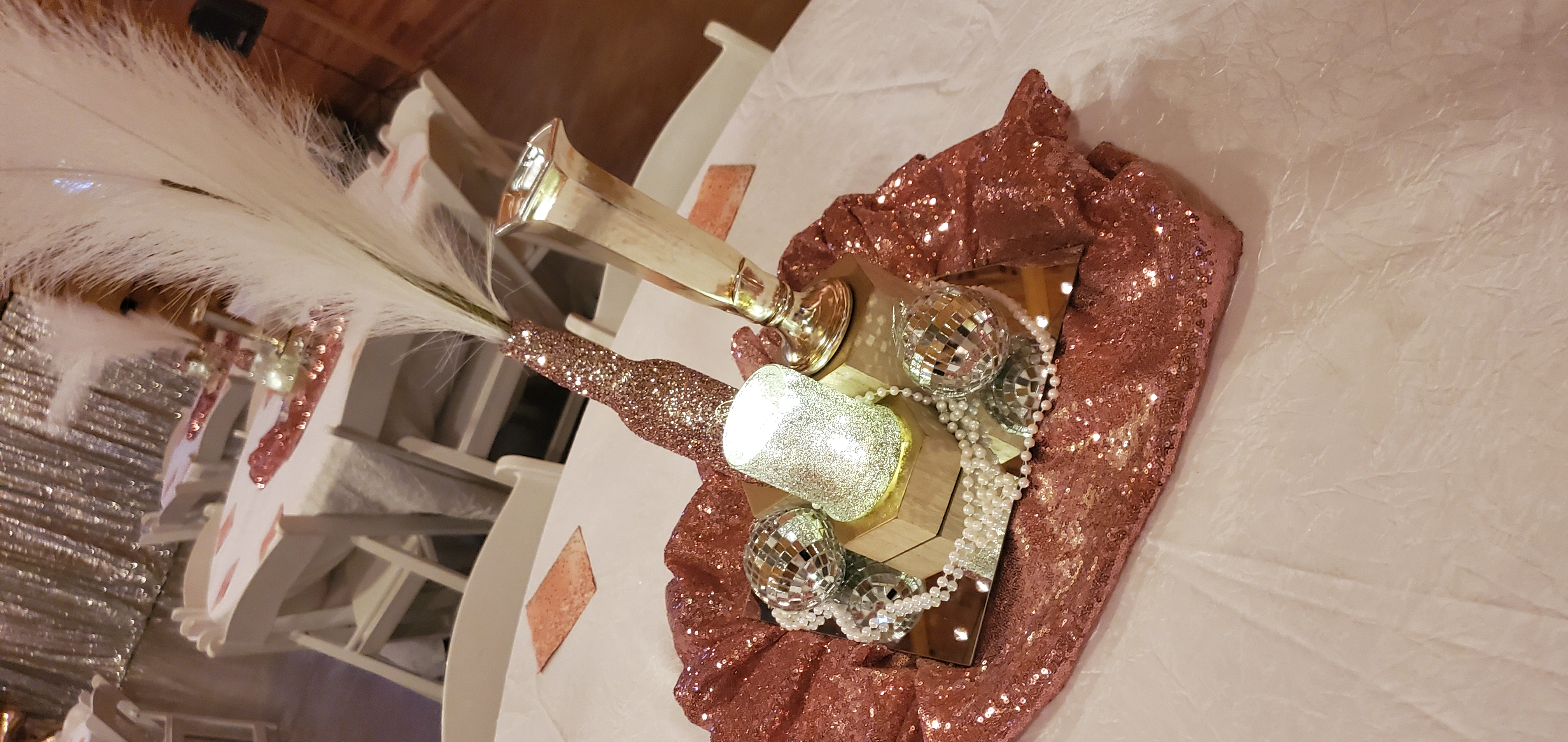 sparkly pink and silver table centerpiece with white feathers