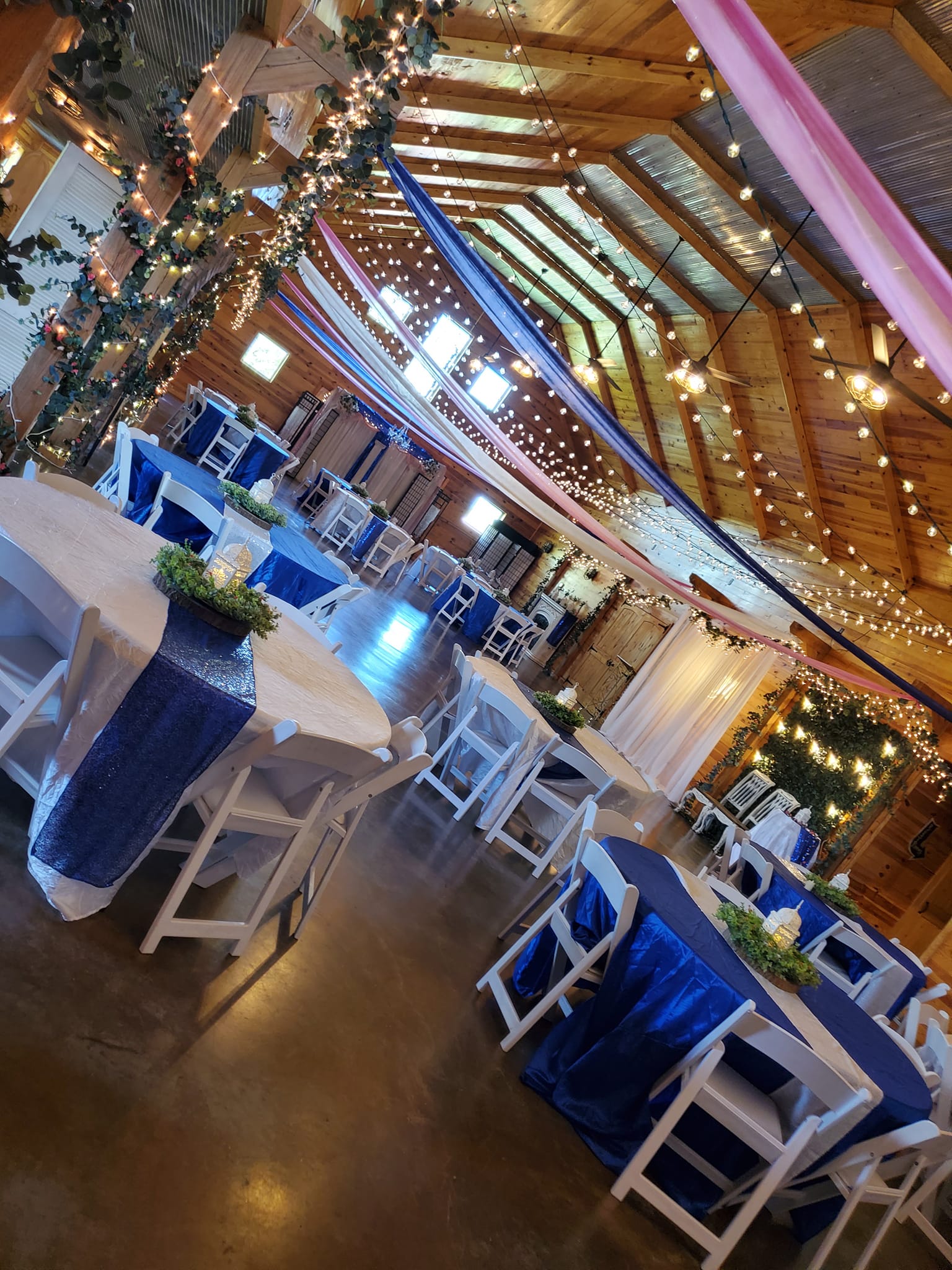 blue and white table linens for party in barn venue