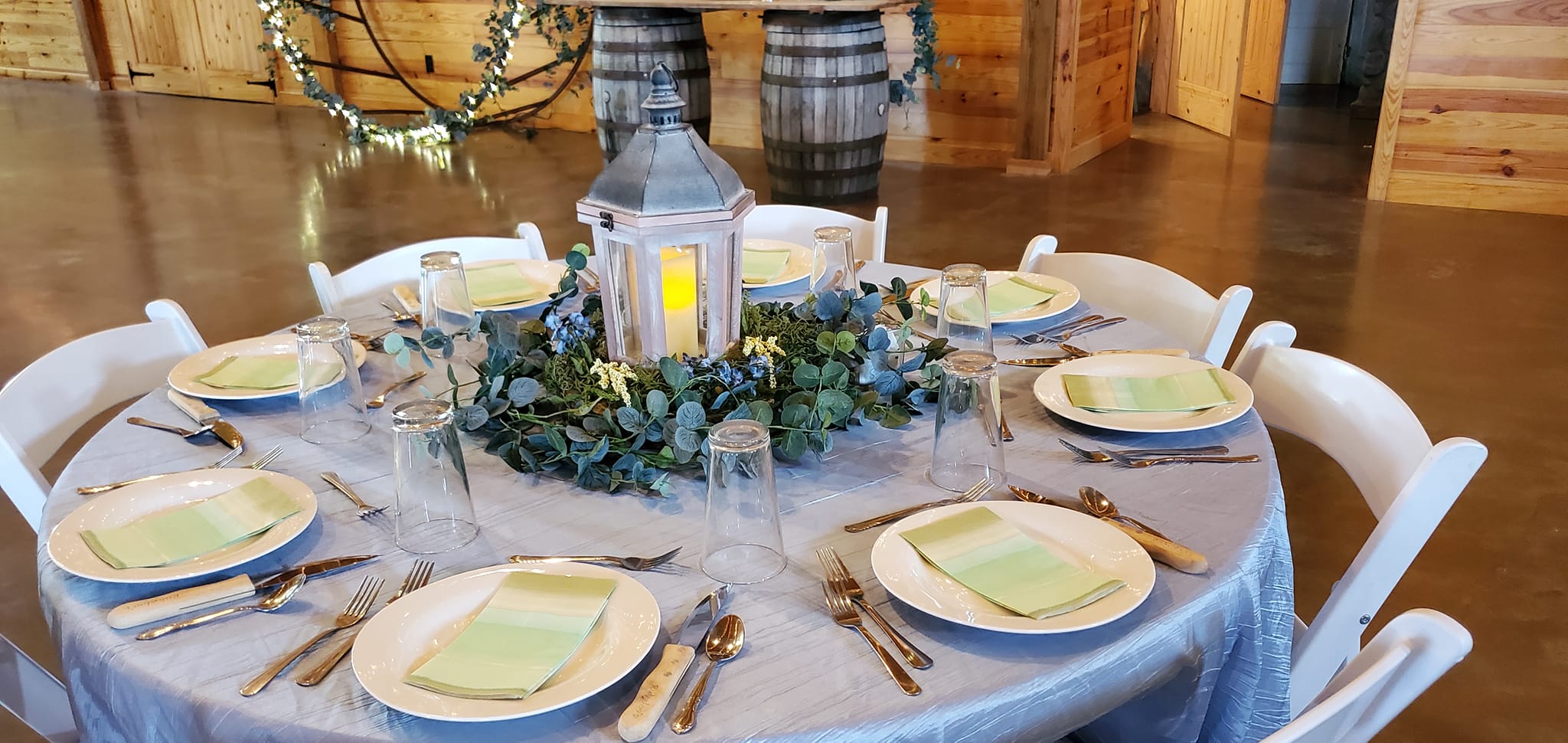 party table with light blue linens and whimsical lantern centerpiece