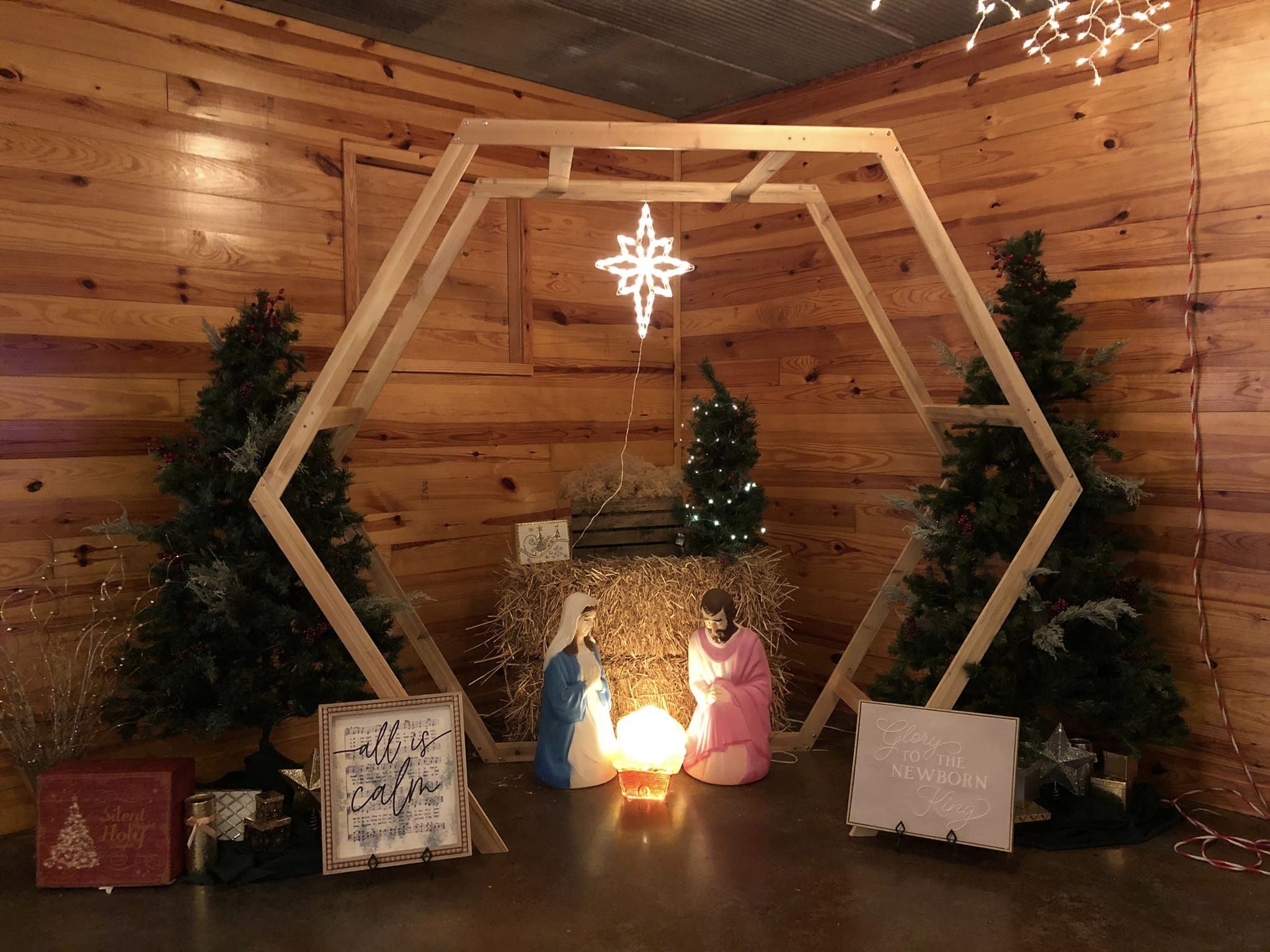 nativity scene set up under wooden arch at Christmas party